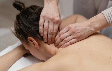 close-up-therapist-massaging-neck-min-scaled